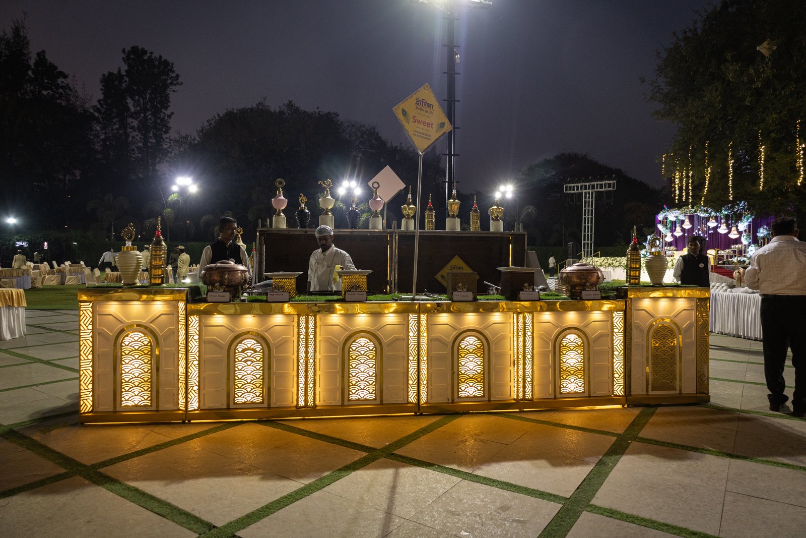 Illuminated live food counter setup at night event